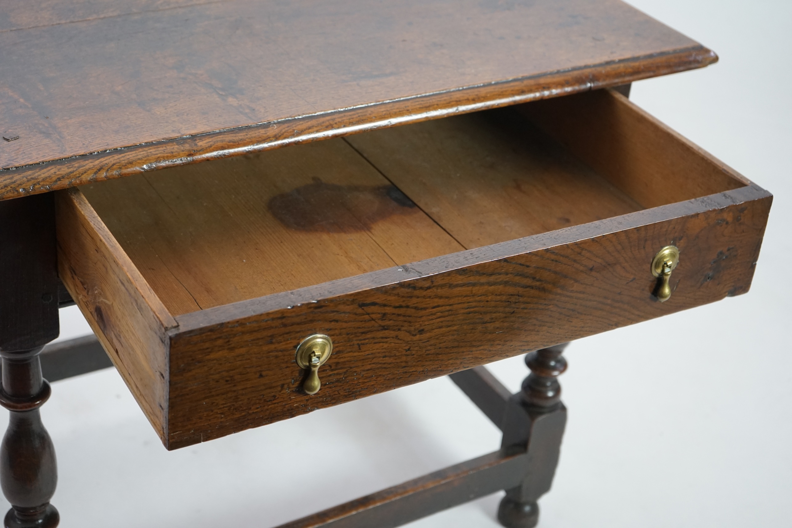 An early 18th century and later oak side table